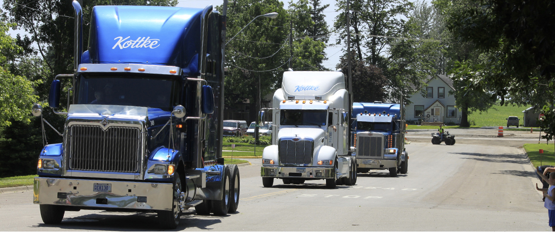 3 Kottke semi trucks driving down road